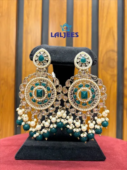 Stunning circular chandbali earrings with green stones and pearl drops, designed to make a statement.