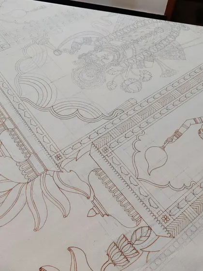 The brown outline of the decorative border and background elements of the Srinathji painting.