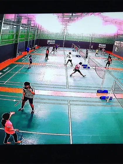 The courts are busy with players of all ages. This wide view captures a typical day at the academy, with kids and adults enjoying the game side by side.
