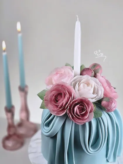 A close-up of the sugar flower bouquet, showing the detailed craftsmanship of each petal.