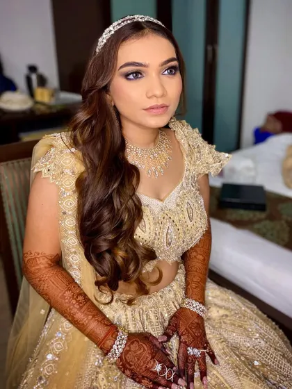 A candid moment, capturing the stunning details of her sangeet makeup. The eyes are the star of the show, with a beautiful blend of shimmer and smoke.