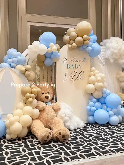 A side-angle view of the "Baby Ali" welcome setup, showing the depth and layering of the balloon clouds, backdrops, and props.