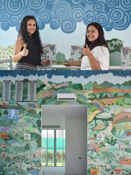 My partner and I in front of the completed 400 sq ft sustainable living mural. This project was a massive undertaking that required detailed planning and execution to cover the entire wall around the entryway.