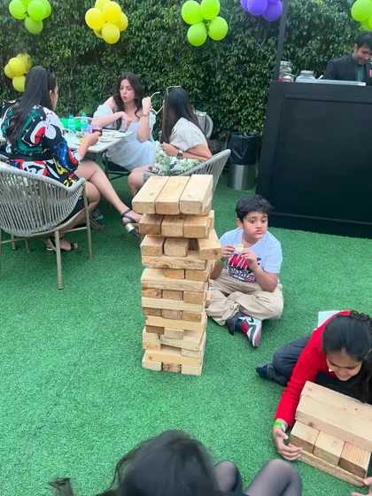 Happy moments at Hoppers, with kids and adults enjoying games like giant Jenga in our outdoor area.