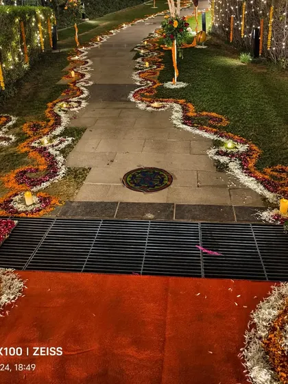 A beautiful walkway for a Diwali event, with the path borders decorated using marigold, rose, and white flower petals.