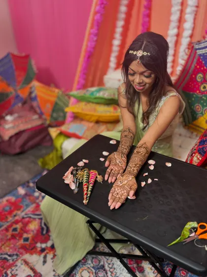 Another candid moment from the mehendi session, capturing the bride's happiness and the beauty of the design.