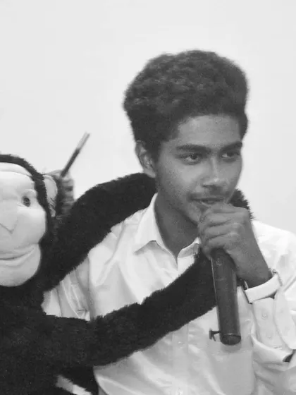 A black and white shot of me performing with my main sidekick, Sandy the monkey. This captures the dynamic between me as the straight man and him as the cheeky comic relief.