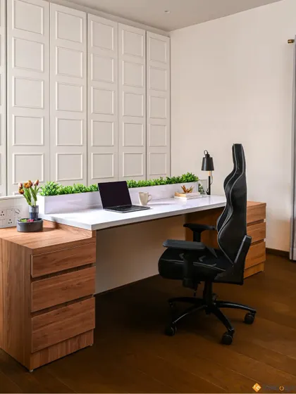 A productive and comfortable work-from-home space with an ergonomic chair, ample desk space, and organized storage.