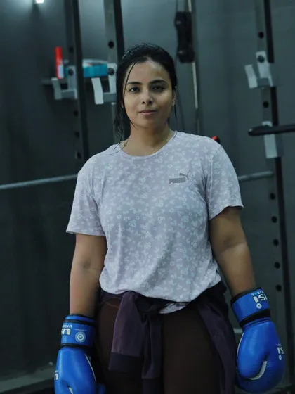A female boxer looking confident and strong after a training session. This is the result of hard work.