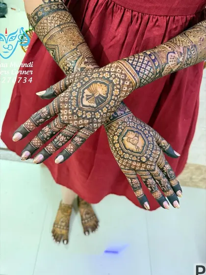 A stylish pose showing the back of the hands. This design features a central lotus mandala, surrounded by a mix of geometric and floral patterns, offering a modern take on traditional mehndi.