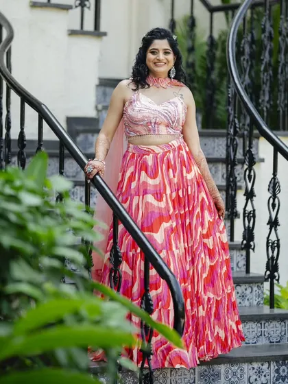 Another shot of the bride on the stairs. Her entire look is a perfect blend of tradition and modern fun for her Goa Haldi ceremony.