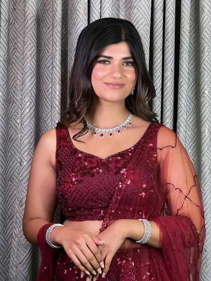 A bold and beautiful look for an evening celebration. This style features dramatic smokey eyes, luminous skin, and soft curls in a rich, sequined red outfit.