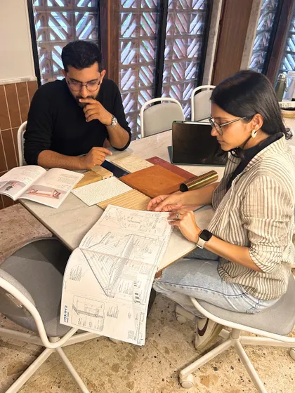 A typical scene in our studio: Sid and Nik discussing plans and material samples. The new extension provides the perfect environment for these deep-dive creative sessions.
