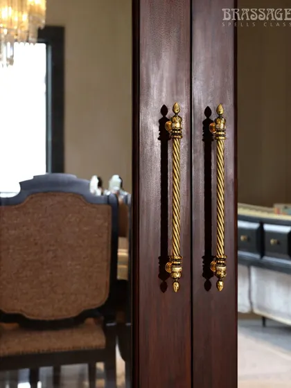A focused shot of the Chelsea pulls against the rich wood of the door, with the elegant dining room visible in the background.