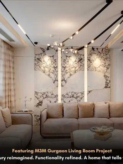 This living room in our M3M Gurgaon project shows how luxury can be functional. The backlit marble panels create a stunning feature wall, while the modern track lighting provides focused illumination without cluttering the ceiling.