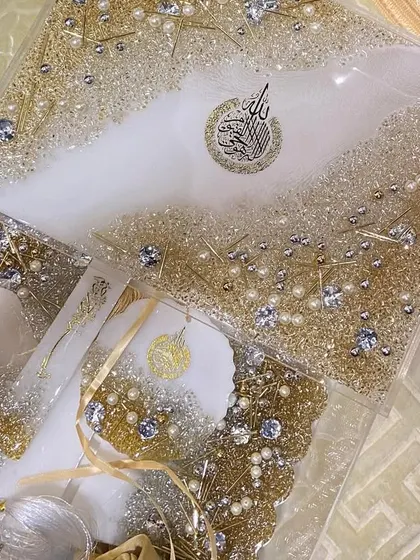 A close-up of the white and gold Eid gift set, focusing on the sparkling details of the Quran box and accessories.