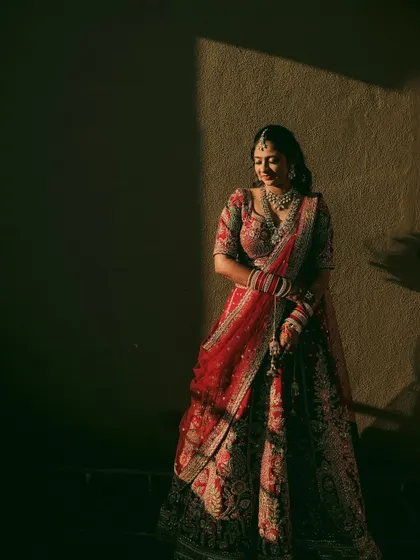 A quiet moment for the bride, captured in a sliver of light, creating a moody and introspective portrait.