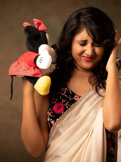 A playful and fun shot of Priyadarshini SK with a Minnie Mouse toy. This shows a different side of her personality and adds a touch of humor to her portfolio.