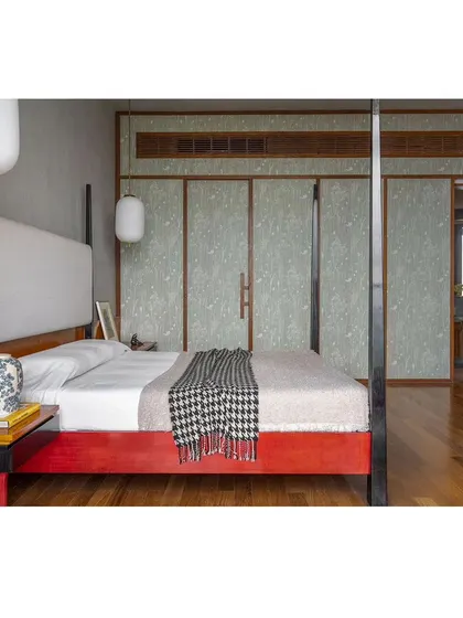 The master bedroom, featuring a custom four-poster bed and wardrobe panels with a subtle, elegant pattern. The design creates a serene and restful retreat.