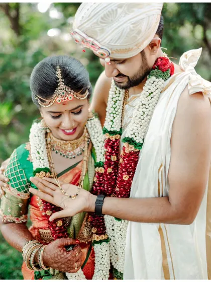 A close-up of the groom showing his bride the wedding ring, a sweet and personal moment.