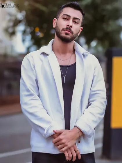 A classic standing portrait, showcasing a simple yet stylish outfit.