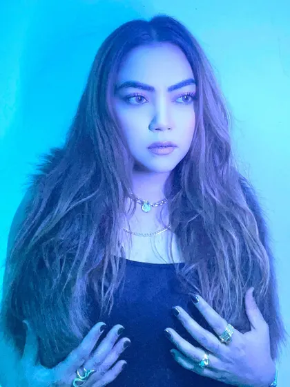 A more introspective portrait with dramatic blue lighting.