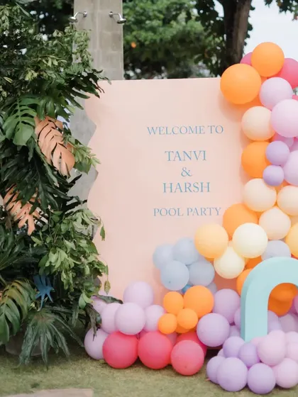 The welcome sign and balloon arrangement being set up for the pool party.