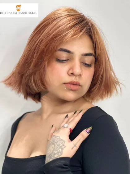 A softer angle of the copper bob, showing the texture and movement in the cut. The color has a beautiful shine, proving that bold color can also be healthy.