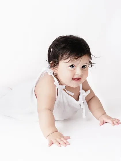 Sometimes the most beautiful portraits are the simplest. This classic, all-white setup lets this little one's sweet expression and curious eyes be the complete focus of the photograph.
