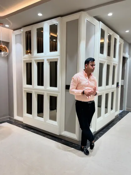 Posing with the finished mirrored wall. This feature completely transforms the living area.