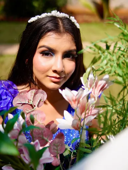 A portrait from the blue gown shoot. The model's eyes are the focus, with a sharp winged liner and a blend of blue eyeshadows.