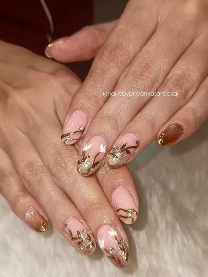 A full look at the hand-painted floral and gold accent nails, showcasing the artistry and care that goes into each set.