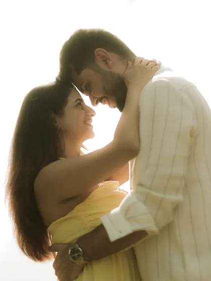 An intimate moment, forehead to forehead, capturing the deep bond and affection between the couple.