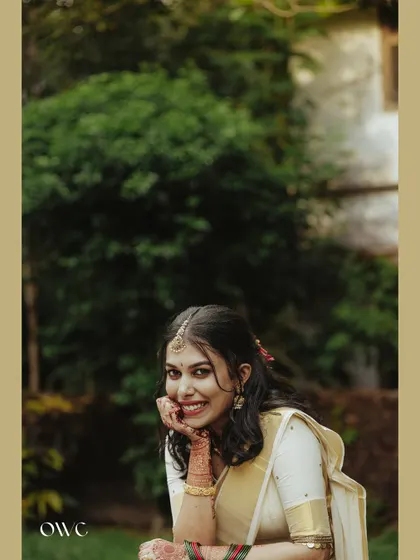 A lovely close-up portrait of the bride, her face resting on her hand.