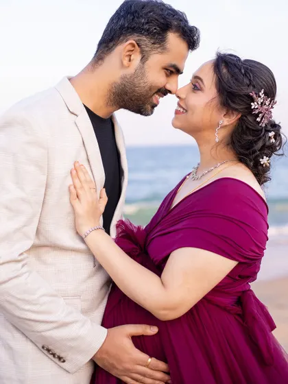 A classic and romantic couple's portrait, filled with love and anticipation, set against the calming backdrop of the ocean.