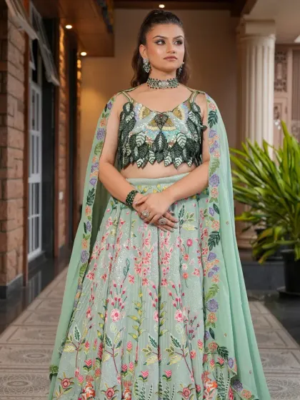 For a fresh and modern pre-wedding or reception look, I recommend this beautiful pastel green floral lehenga. The unique leaf-patterned blouse and light, airy skirt are perfect for daytime functions or an outdoor celebration.