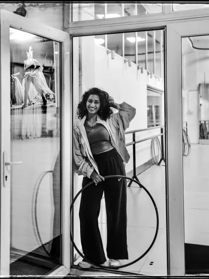 Eshna, a hoop dancer, in her studio. This portrait captures her passion and the joy she finds in her craft.