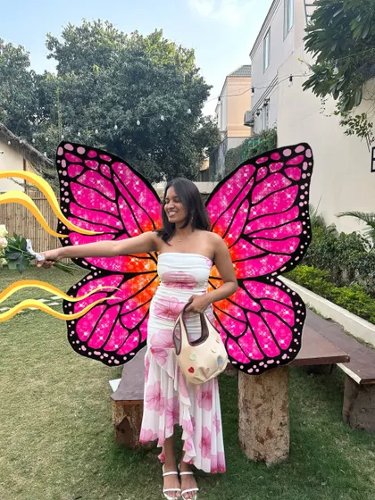 Goofy and artsy. A photo of me with a flower gets a pair of giant, vibrant butterfly wings.