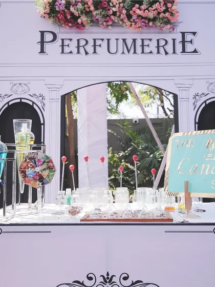 A charming 'Perfumerie' and candle-making station, designed with elegant line art details to fit the European carnival theme.