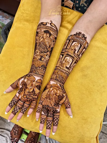 A heavy bridal design with multiple stories, including a jharokha design filled with different couple portraits and a beautiful peacock motif.