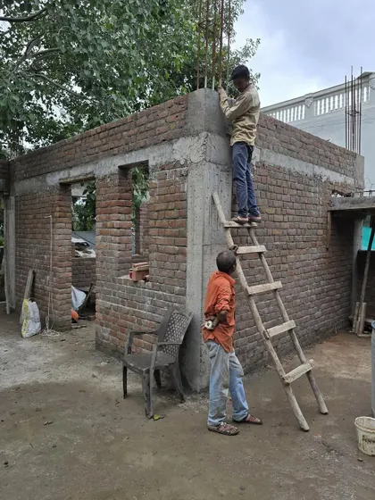 **Dwelling in Frames, Ahmedabad:** Workers on site, carefully laying the brickwork that defines this home. Our process is hands-on, and we value the craftsmanship that brings our architectural visions to life.