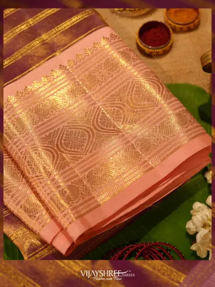 A detailed shot of the heavy gold zari pallu, showcasing the craftsmanship of this festive piece.