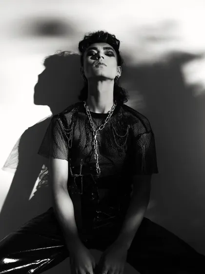 A powerful pose using dramatic shadows. This black and white image is both artistic and strong, perfect for a high-fashion portfolio.
