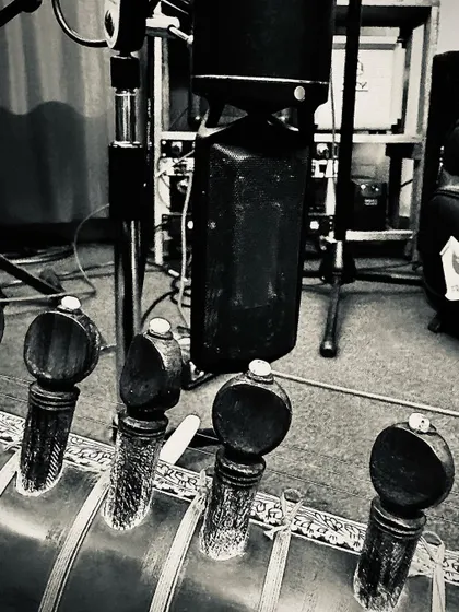 A close-up of my sitar being miked up in the studio. Proper microphone placement is key to capturing the rich, authentic tone of the instrument during a recording session.
