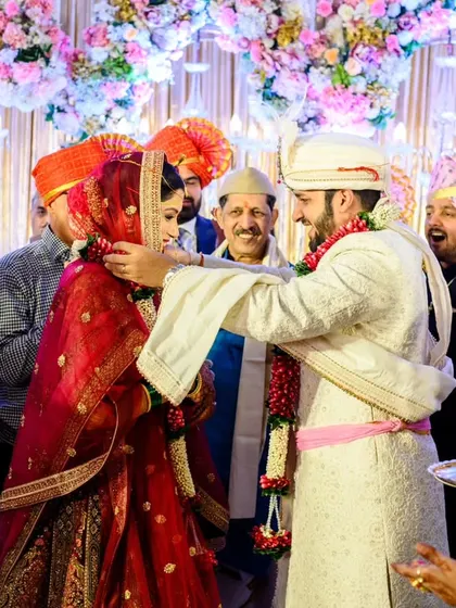 The final moment of the exchange. Aakash garlands Shruti, sealing the ritual amidst the smiles of their loved ones at the Sheraton Grand Pune.