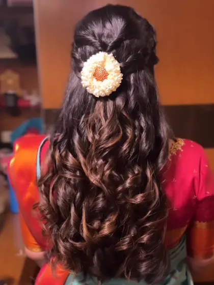 Another angle of the half-braided, curly hairstyle, showing the beautiful texture.