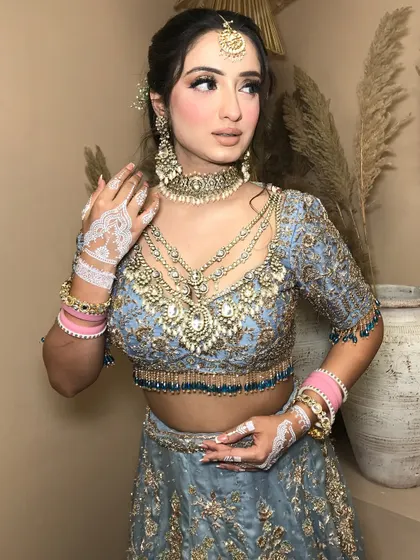 A close-up that captures the soft glam and the intricate details of the bridal jewelry.