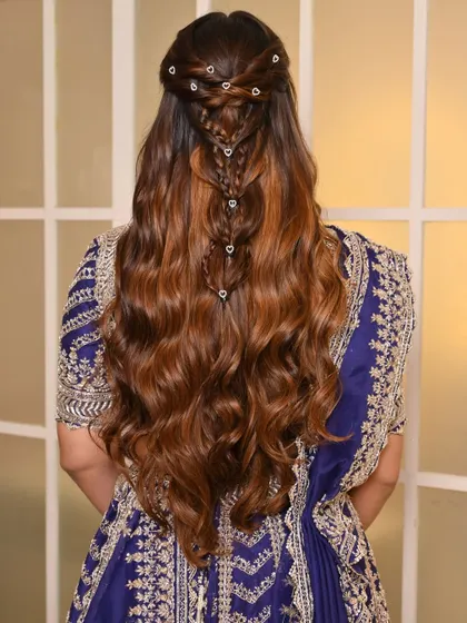 A view of the intricate hairstyle for the sangeet. The beautiful braid detail adds another layer of elegance to the overall look, proving that beauty is in every detail.