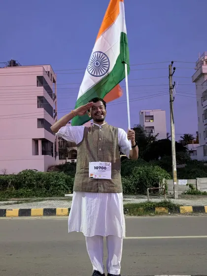 A participant salutes while holding the Indian flag, a powerful image of respect and pride from our Independence Day run.