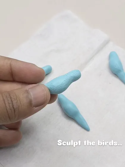 The process begins with sculpting the tiny birds, each one shaped by hand to give it character.